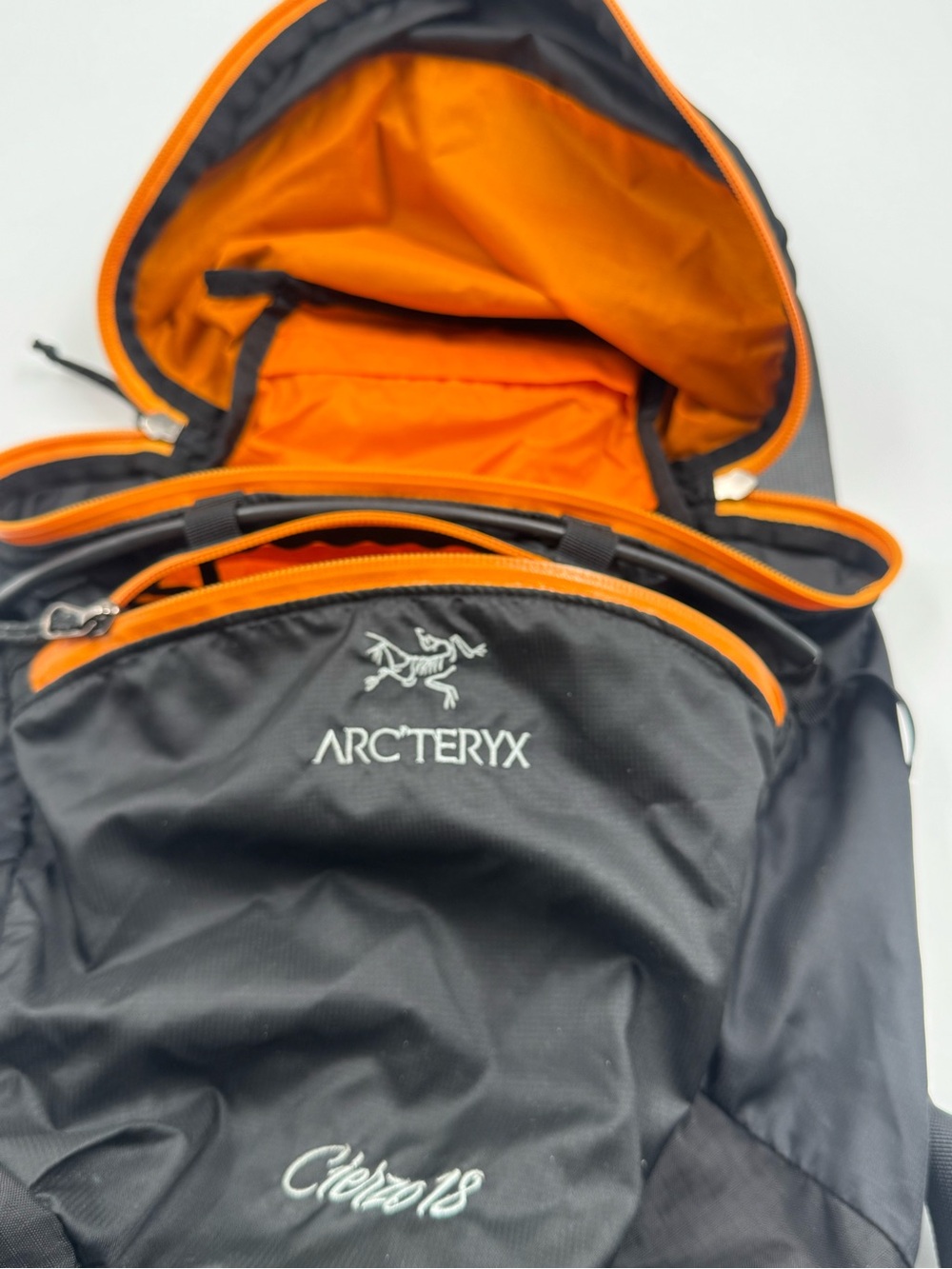 Arc'teryx Black Backpack with Orange Interior Accents